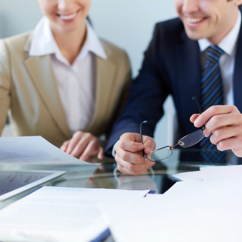 Business partners discussing document at meeting